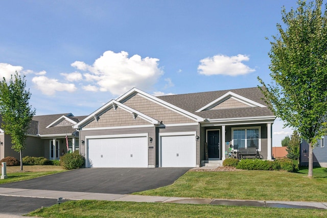 630 Stonegate Cir, Waconia, MN 55387 - view of front of house featuring a garage, a front yard, driveway, and covered porch
