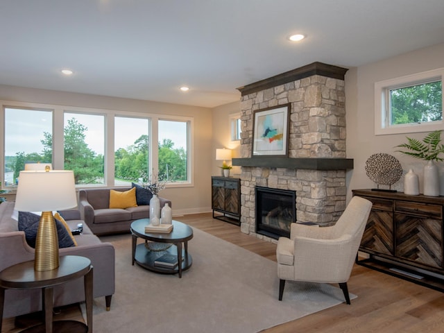 9160 62nd St S, Cottage Grove, MN 55016 - living room featuring wood finished floors, a stone fireplace, and recessed lighting