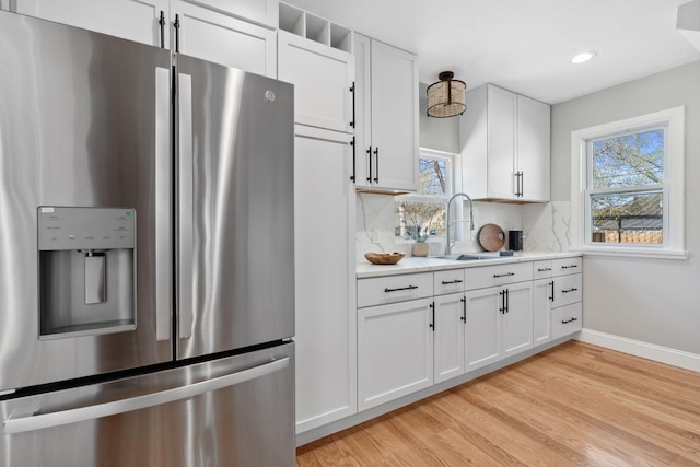 4015 Queen Ave N, Minneapolis, MN 55412 - kitchen with a healthy amount of sunlight, light countertops, stainless steel fridge with ice dispenser, and a sink