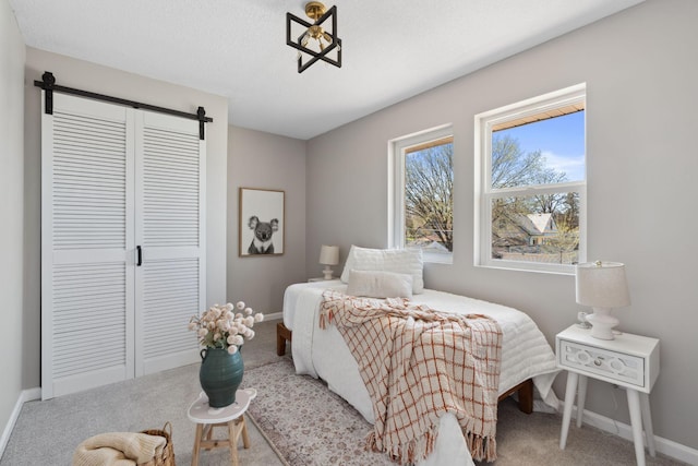 4015 Queen Ave N, Minneapolis, MN 55412 - bedroom with a barn door, carpet, baseboards, and a closet