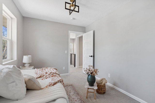 4015 Queen Ave N, Minneapolis, MN 55412 - carpeted living area featuring baseboards and a notable chandelier