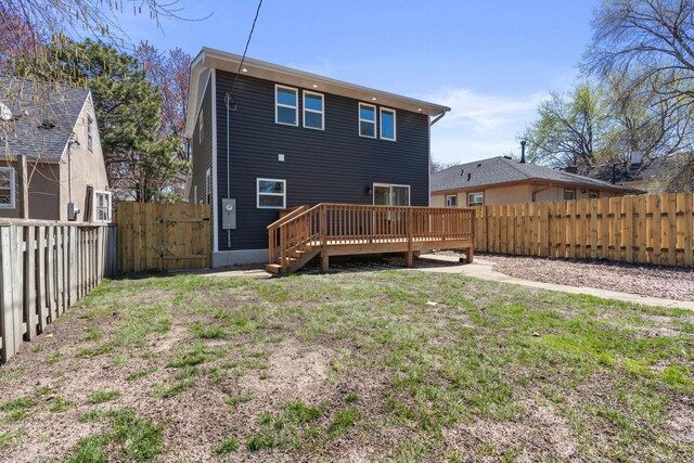 4015 Queen Ave N, Minneapolis, MN 55412 - back of property featuring a lawn, a deck, a fenced backyard, and a gate