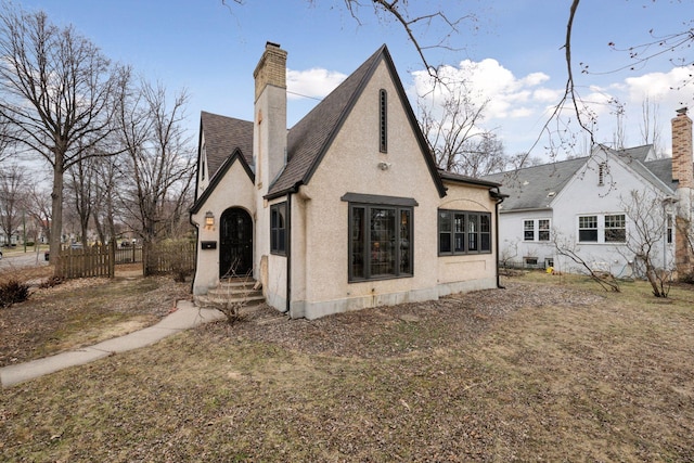 300 Diamond Lake Rd, Minneapolis, MN 55419 - back of property featuring a chimney, a shingled roof, stucco siding, and fence