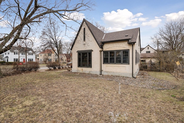 300 Diamond Lake Rd, Minneapolis, MN 55419 - back of house featuring roof with shingles, fence, and stucco siding