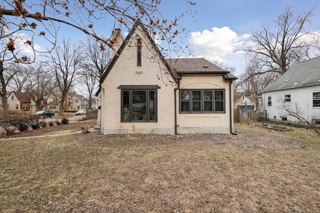 300 Diamond Lake Rd, Minneapolis, MN 55419 - rear view of house featuring fence, stucco siding, and a chimney