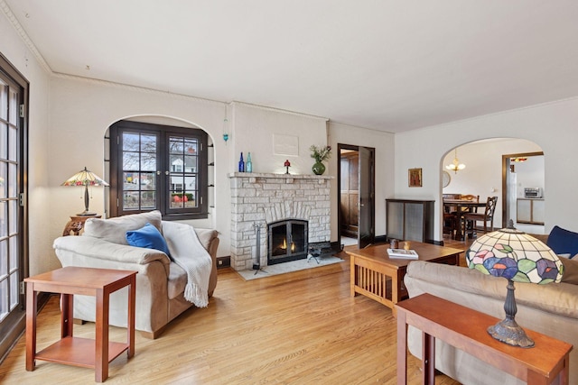 300 Diamond Lake Rd, Minneapolis, MN 55419 - living room with arched walkways, a fireplace, light wood-type flooring, and ornamental molding