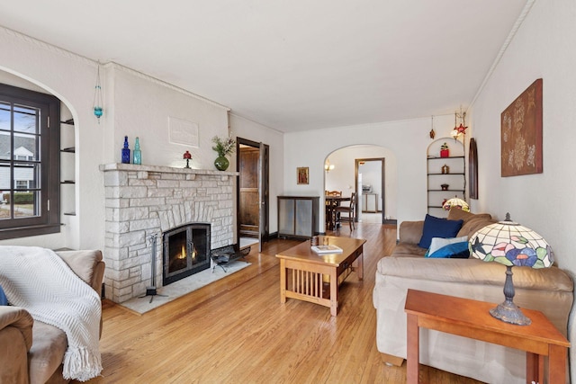 300 Diamond Lake Rd, Minneapolis, MN 55419 - living room with ornamental molding, light wood-type flooring, arched walkways, and a fireplace