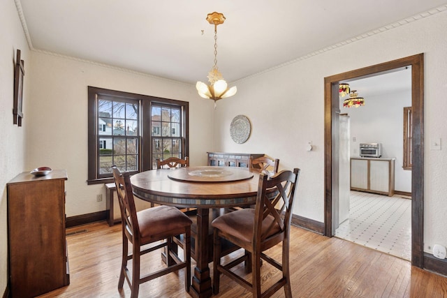300 Diamond Lake Rd, Minneapolis, MN 55419 - dining area with baseboards, an inviting chandelier, ornamental molding, visible vents, and light wood finished floors