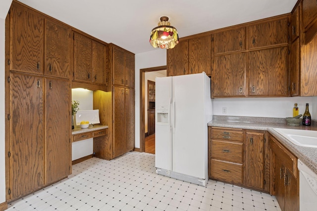 300 Diamond Lake Rd, Minneapolis, MN 55419 - kitchen featuring brown cabinets, a sink, white appliances, and light floors