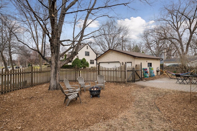 300 Diamond Lake Rd, Minneapolis, MN 55419 - view of yard with an outbuilding, fence private yard, an outdoor fire pit, a patio area, and an attached garage