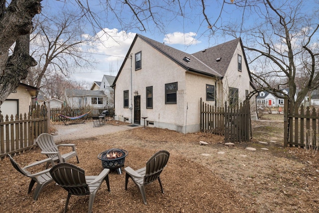 300 Diamond Lake Rd, Minneapolis, MN 55419 - rear view of property with roof with shingles, stucco siding, a fire pit, a patio area, and fence