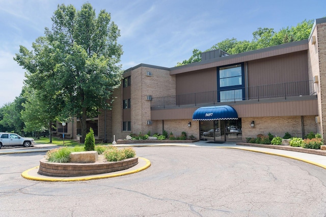 view of property featuring uncovered parking