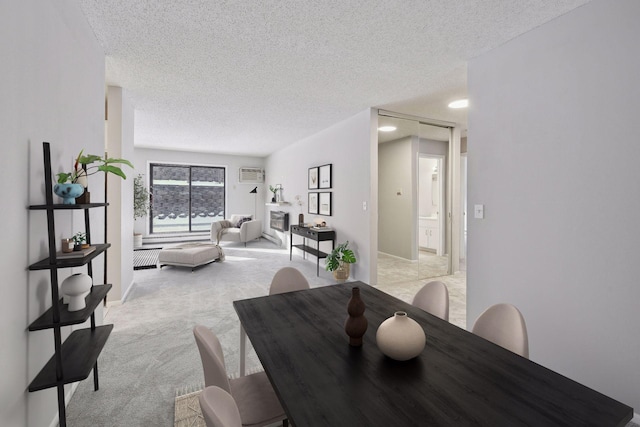 dining area featuring light colored carpet and a textured ceiling