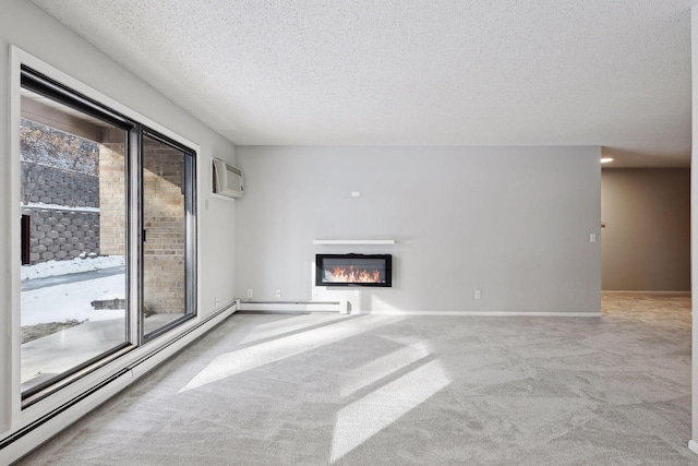 unfurnished living room featuring a wealth of natural light, carpet flooring, a textured ceiling, and a wall unit AC