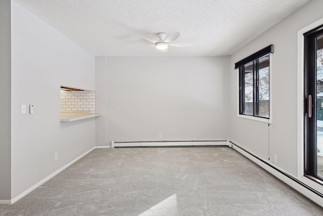 carpeted empty room with baseboard heating, baseboards, a baseboard heating unit, a textured ceiling, and a ceiling fan
