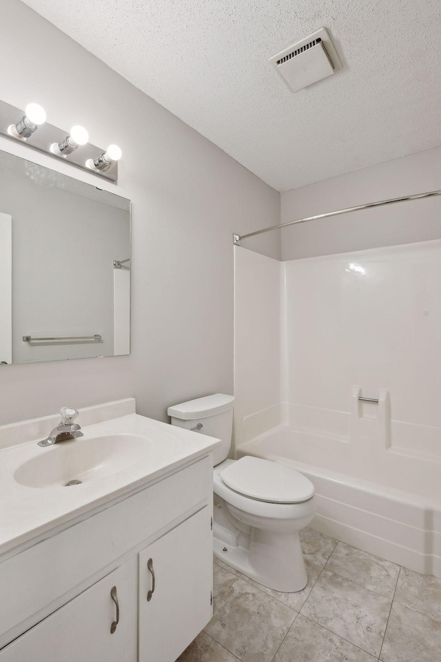 bathroom featuring vanity, visible vents, a textured ceiling, and toilet
