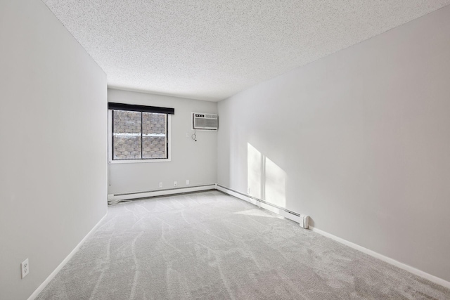 spare room featuring baseboards, carpet, a textured ceiling, and a wall unit AC