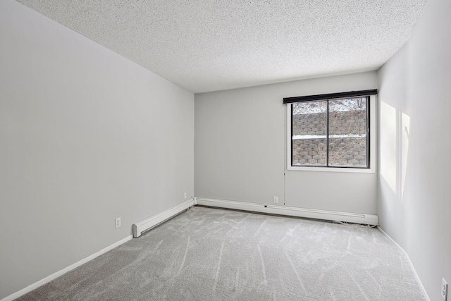 unfurnished room with baseboards, carpet flooring, a baseboard heating unit, and a textured ceiling