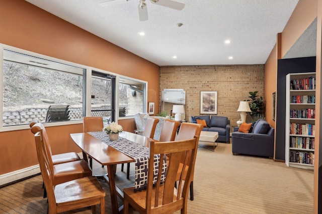 dining area featuring brick wall, a ceiling fan, recessed lighting, and a textured ceiling