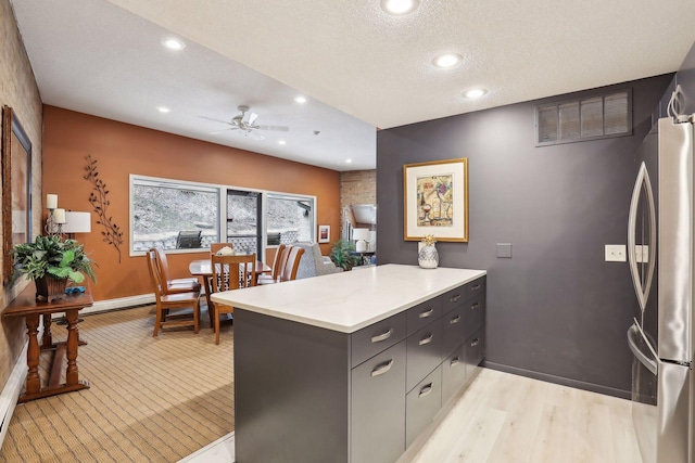 kitchen featuring recessed lighting, freestanding refrigerator, a peninsula, and a ceiling fan