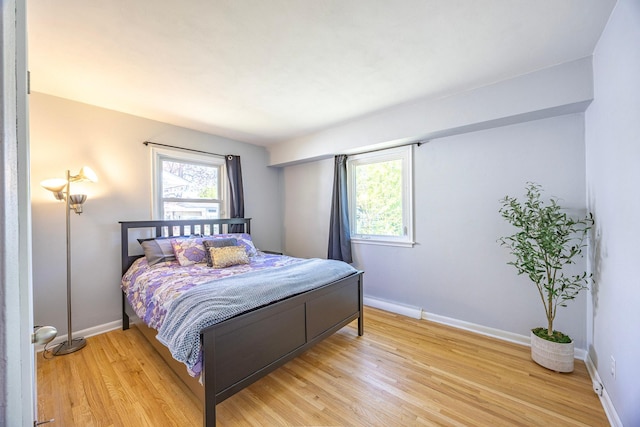 bedroom featuring light wood-style flooring and baseboards