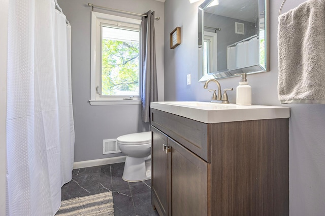 full bath featuring toilet, vanity, baseboards, and marble look tile flooring