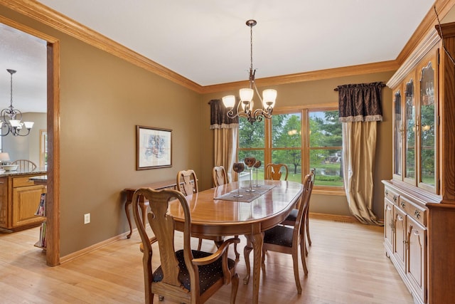 268 Saint Andrews Dr, Hudson, WI 54016 - dining area with a chandelier, baseboards, light wood-style floors, and ornamental molding