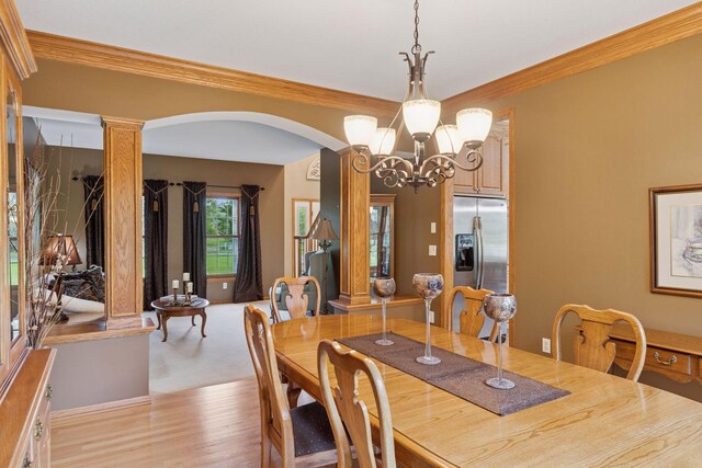 268 Saint Andrews Dr, Hudson, WI 54016 - dining room with a chandelier, light wood-style floors, arched walkways, and ornamental molding