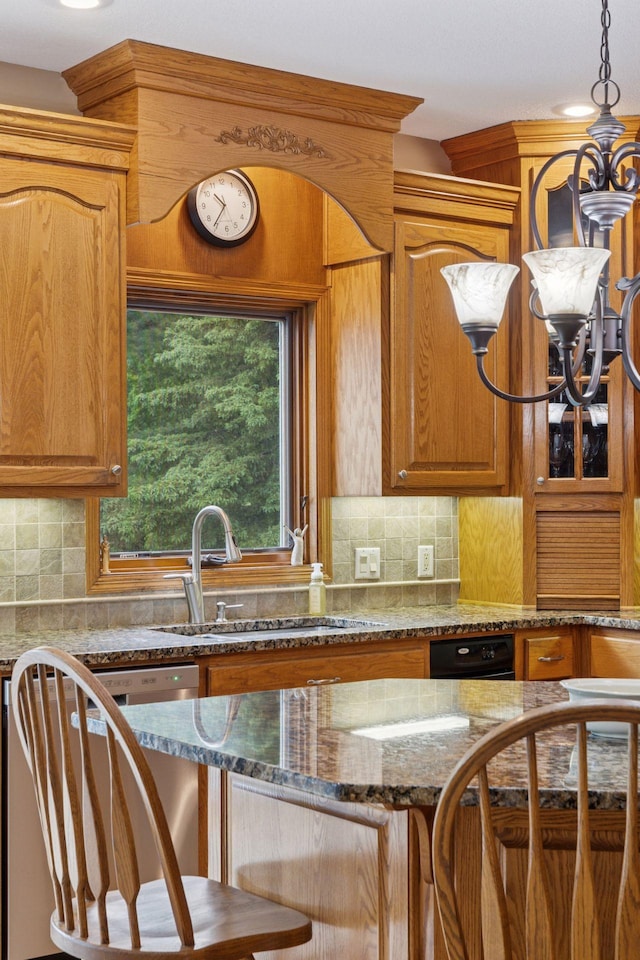 268 Saint Andrews Dr, Hudson, WI 54016 - kitchen with stainless steel dishwasher, a sink, decorative backsplash, dark stone countertops, and brown cabinetry