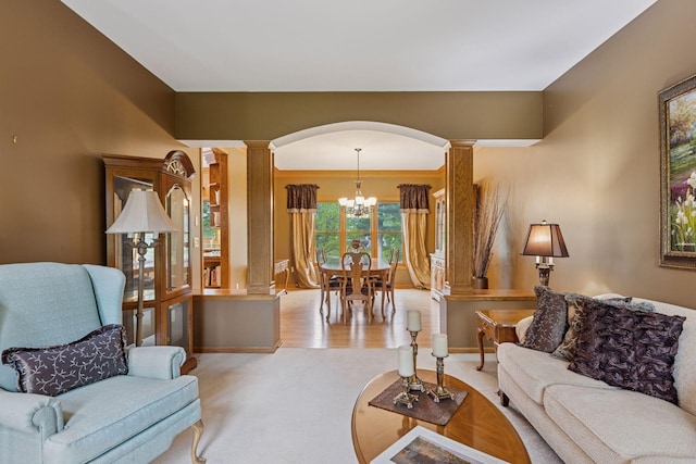 268 Saint Andrews Dr, Hudson, WI 54016 - carpeted living area with ornate columns, arched walkways, a chandelier, and baseboards