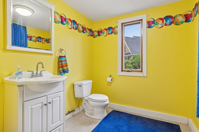 268 Saint Andrews Dr, Hudson, WI 54016 - bathroom featuring vanity, toilet, baseboards, and tile patterned floors