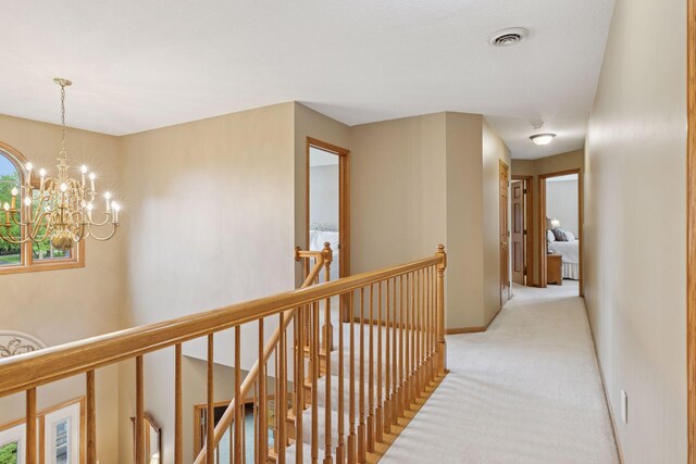 268 Saint Andrews Dr, Hudson, WI 54016 - hallway with an upstairs landing, light carpet, a chandelier, and baseboards