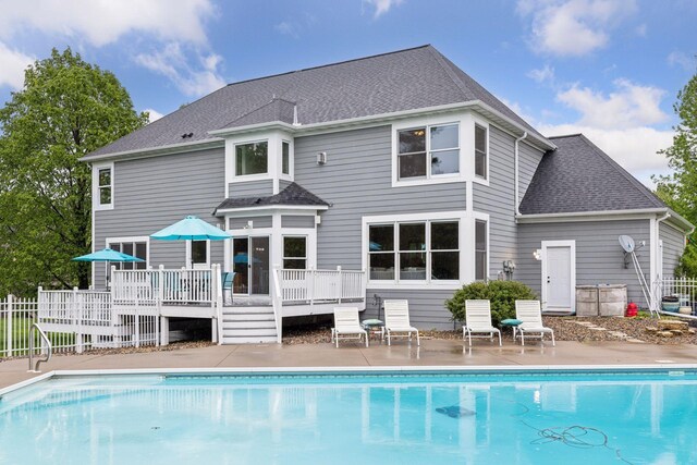 268 Saint Andrews Dr, Hudson, WI 54016 - rear view of property featuring a deck, an outdoor pool, roof with shingles, and a patio area