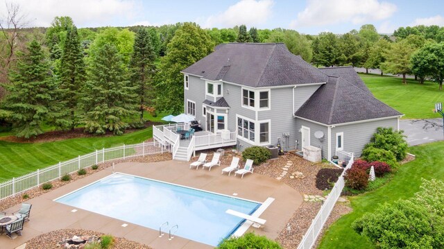 268 Saint Andrews Dr, Hudson, WI 54016 - back of property with a deck, a patio, a shingled roof, and central AC