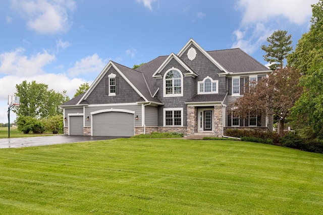 268 Saint Andrews Dr, Hudson, WI 54016 - view of front of home with stone siding, driveway, a front lawn, and an attached garage