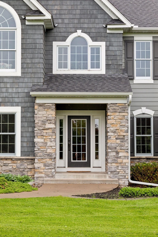 268 Saint Andrews Dr, Hudson, WI 54016 - doorway to property featuring stone siding and a shingled roof