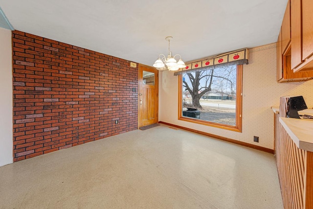 101 State Highway 60 E, Elysian, MN 56028 - unfurnished dining area with a chandelier, brick wall, and wallpapered walls