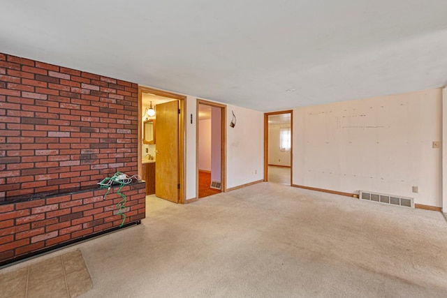 101 State Highway 60 E, Elysian, MN 56028 - unfurnished living room featuring carpet flooring, baseboards, and brick wall