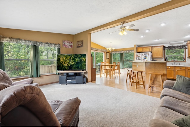 969 Dosh Rd, Fort Ripley, MN 56449 - living area with lofted ceiling with beams, ceiling fan with notable chandelier, light colored carpet, and recessed lighting