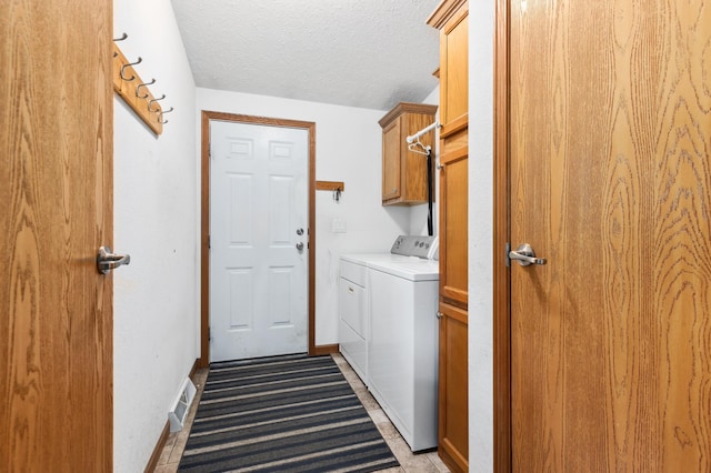 969 Dosh Rd, Fort Ripley, MN 56449 - laundry room featuring a textured ceiling, visible vents, baseboards, washer and dryer, and cabinet space