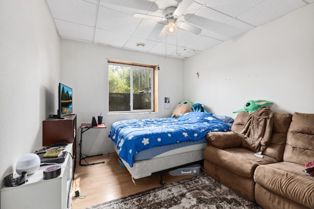 969 Dosh Rd, Fort Ripley, MN 56449 - bedroom featuring a ceiling fan, wood finished floors, and a drop ceiling