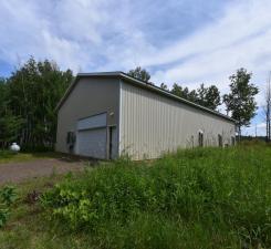 view of home's exterior with a detached garage