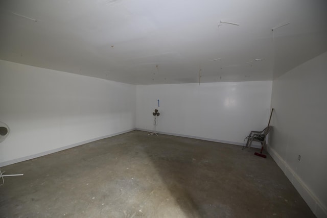 additional living space with baseboards and concrete flooring