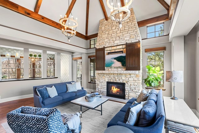 425 Carpenters Pt, Wayzata, MN 55391 - living area featuring a stone fireplace, a high ceiling, beamed ceiling, wood finished floors, and a chandelier