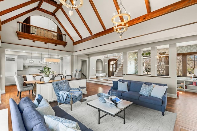 425 Carpenters Pt, Wayzata, MN 55391 - living area with a chandelier, high vaulted ceiling, stairway, wood-type flooring, and arched walkways
