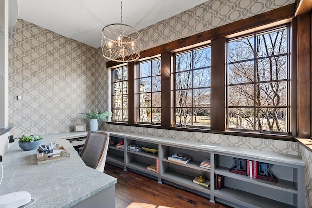 425 Carpenters Pt, Wayzata, MN 55391 - dining space featuring wallpapered walls, a chandelier, plenty of natural light, dark wood finished floors, and an office area