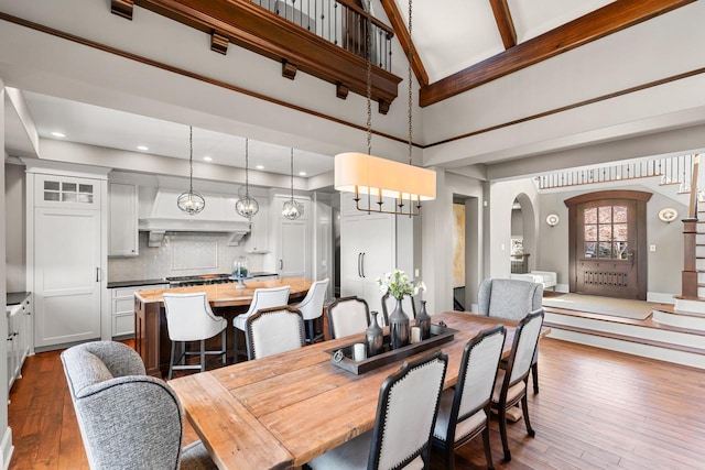 425 Carpenters Pt, Wayzata, MN 55391 - dining area with high vaulted ceiling, arched walkways, dark wood finished floors, a chandelier, and stairway