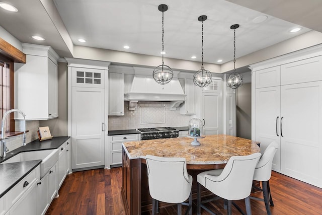 425 Carpenters Pt, Wayzata, MN 55391 - kitchen with a sink, recessed lighting, custom exhaust hood, range, and decorative backsplash