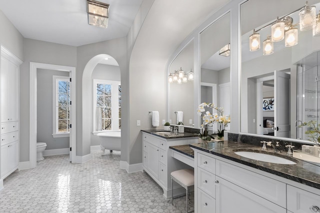 425 Carpenters Pt, Wayzata, MN 55391 - full bathroom with vanity, a soaking tub, toilet, and baseboards