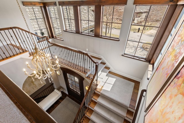 425 Carpenters Pt, Wayzata, MN 55391 - stairway with baseboards and a chandelier